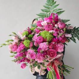 Large pink bouquet with roses and carnations tied with ribbon