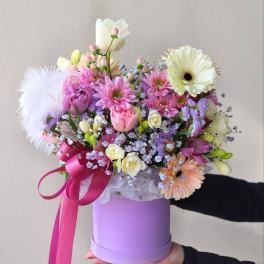 Pastel bouquet in a lavender hatbox with a pink ribbon