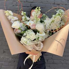 Large bouquet of white and blush roses with calla lilies and airy white blooms