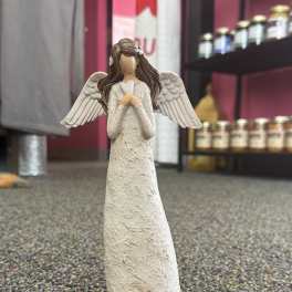 White angel figurine with wings and clasped hands