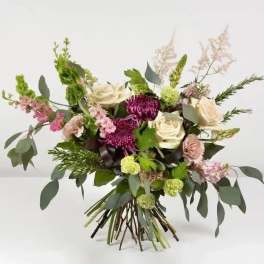 Bouquet of cream and purple flowers with airy greenery