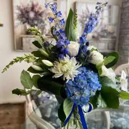 Blue and white bouquet with hydrangeas, lilies, and a ribbon