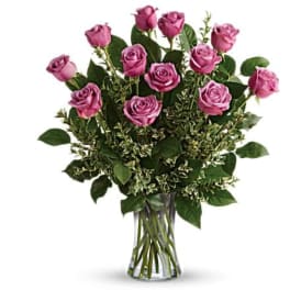 Pink roses arranged in a clear glass vase