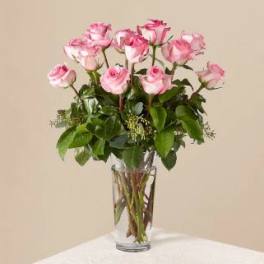 Pink roses arranged in a clear glass vase