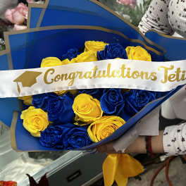 Blue and yellow rose bouquet with a graduation sash