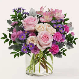 Pink and purple mixed bouquet in a clear glass vase