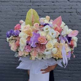 Large pastel flower arrangement in a white hat box