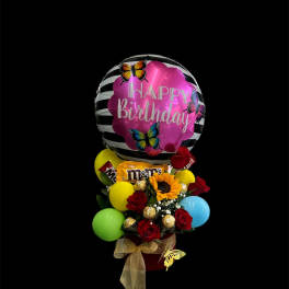 Birthday balloon arrangement with roses, sunflower, and candy