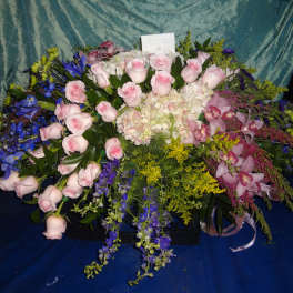Large mixed bouquet with pink roses, orchids, and blue flowers
