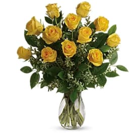 Yellow roses arranged in a clear glass vase
