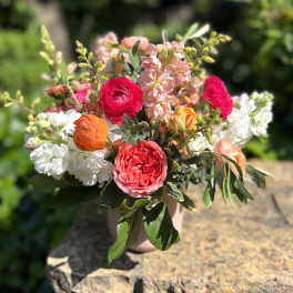 Mixed bouquet of pink, white, and orange flowers in a vase