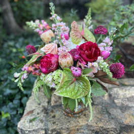 Mixed bouquet in a glass vase with pink and green blooms