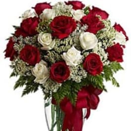 Bouquet of red and white roses in a clear glass vase