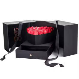 Red roses in a black gift box with ribbon handles