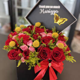 Red and pink roses in a black gift box with a thank-you sign