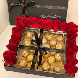 Red roses framing a gift box of Ferrero Rocher chocolates