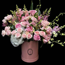 Pink rose bouquet in a round pink box with butterfly accents