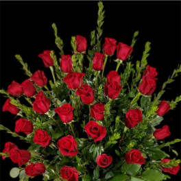 Bouquet of red roses with greenery in a basket