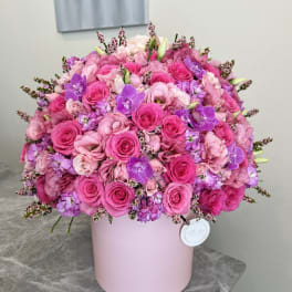 Pink and purple rose bouquet in a pale pink hat box