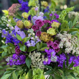 Bouquet of purple and green flowers with white filler blooms