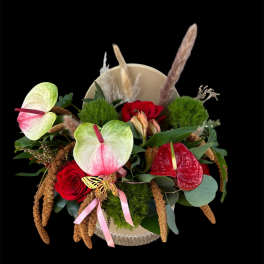 Mixed bouquet with red roses and pink anthuriums in a round box