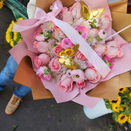 Pink rose and ranunculus bouquet with gold butterfly accents