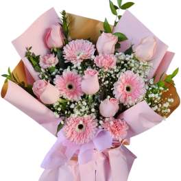 Pink rose and gerbera daisy bouquet wrapped in pastel paper