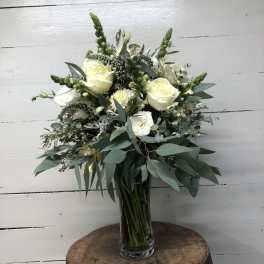 White rose bouquet in a clear glass vase