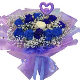 Bouquet of blue and purple roses with baby's breath and a heart topper