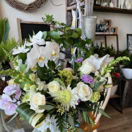 Large bouquet of white orchids and roses with lavender accents