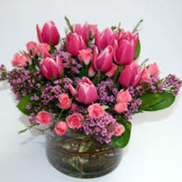 Pink tulips and spray roses in a glass vase