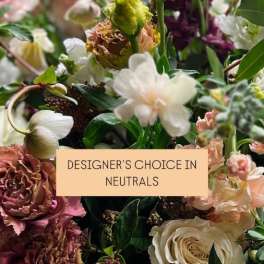 Mixed bouquet of neutral-toned flowers with a label reading designer's choice in neutrals