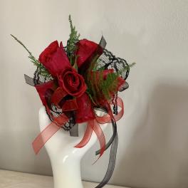 Red rose corsage and boutonniere with black and red ribbon accents