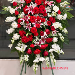 Standing floral spray with red and white roses and pink lilies