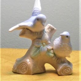 Ceramic figurine of two birds on a branch