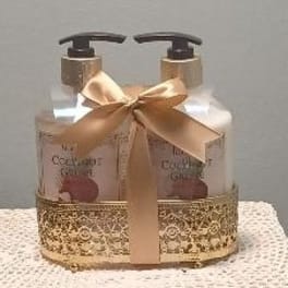 Two clear pump bottles tied with a gold ribbon