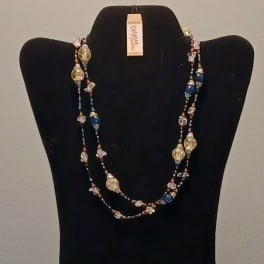 Beaded necklace displayed on a black bust stand