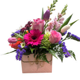Mixed bouquet in a pink box with roses, tulips, and gerbera daisies