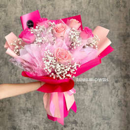 Pink rose bouquet with baby's breath and bright ribbon wrapping