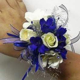 Blue and white wrist corsage with ribbon accents