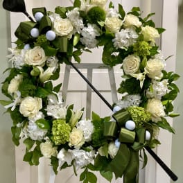 Floral wreath with white roses and lilies on a stand