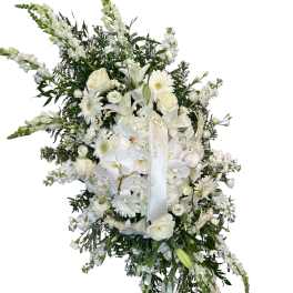 White funeral spray with roses, lilies, orchids, and daisies