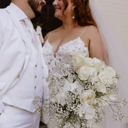 Bride and groom holding a cascading white wedding bouquet