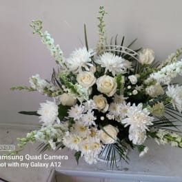 White floral arrangement with roses and chrysanthemums in a vase
