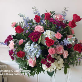 Mixed bouquet of red and pink roses with blue and white flowers
