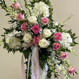 Standing floral cross with pink and white roses and white blooms