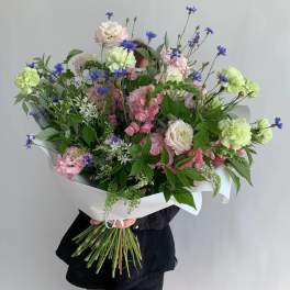 Large bouquet of pink and white flowers with blue accents