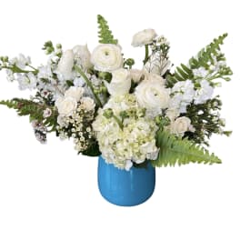 White floral arrangement in a bright blue vase