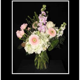 Pink and white mixed bouquet in a clear glass vase