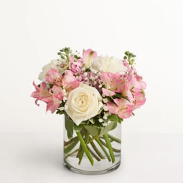 Pink and white bouquet in a clear glass vase